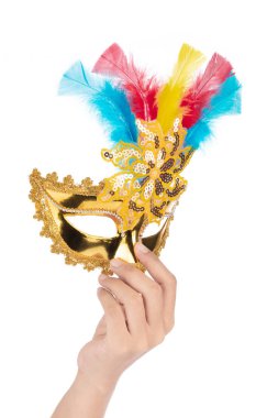Hand holding Beautiful of gold mask with feather isolated on a w