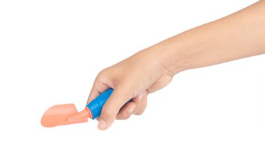 Hand holding toy shovel isolated on white background