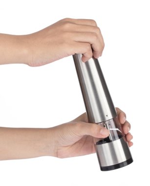 Hand holding Deluxe stainless steel table condiment bottles isol