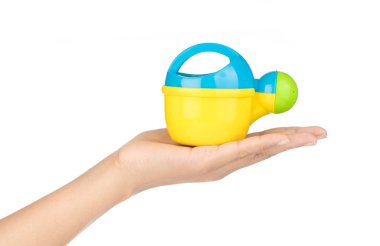 close up of toy watering can isolated on white background