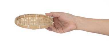 Hand holding a bamboo winnowing trays isolated on a white backgr