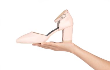 hand holding Beige female strap heels leather stiletto shoes iso