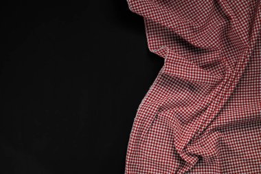 red checkered tablecloth on black background
