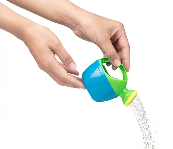 Hand holding a small plastic watering can with spout isolated on — Stok fotoğraf