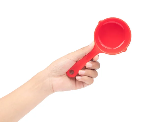 Hand holding red plastic scoop isolated on white background — Stock Photo, Image