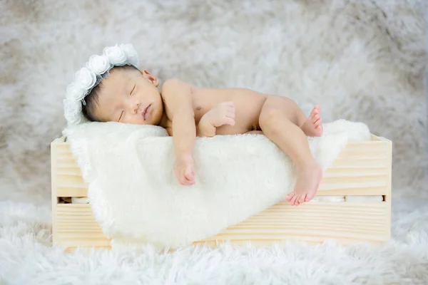 Un bebé recién nacido durmiendo en una caja de madera . —  Fotos de Stock