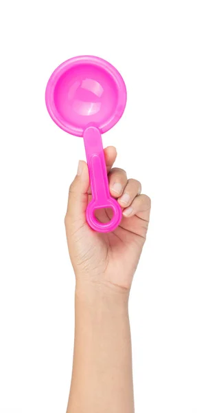 Hand holding Toy plastic pink of shovel isolated on a white back — ストック写真