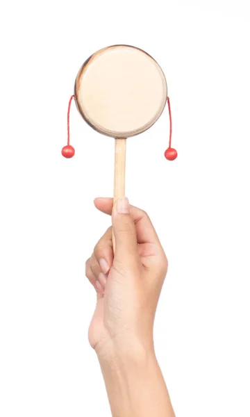 Hand holding Denden daiko folk art toy isolated on a white backg — 图库照片