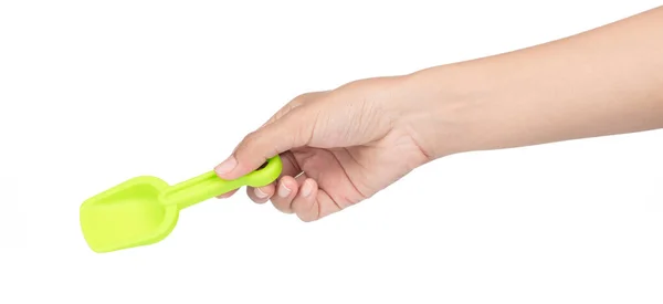 Hand holding Small plastic toy shovel isolated on a white backgr — Stock Photo, Image