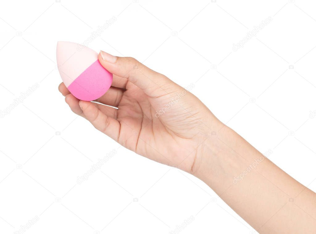 hand holding Pink egg beauty sponge isolated on a white backgrou