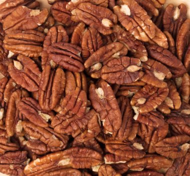 wood dish of pecan nuts isolated on white background