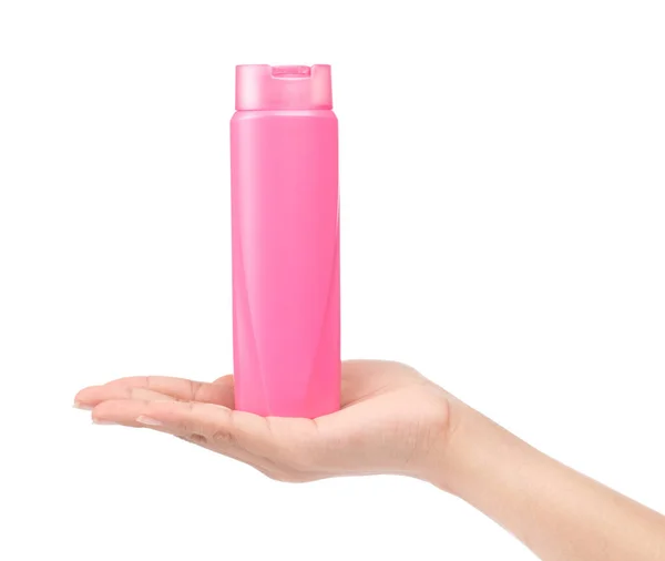 Mano sosteniendo Pink Botella de plástico de champú aislado en blanco ba —  Fotos de Stock