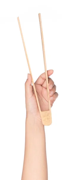 Mão segurando pinças de colher de madeira isoladas no fundo branco — Fotografia de Stock