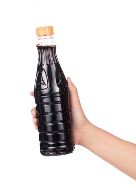 hand holding Soy Sauce bottle isolated on white background.