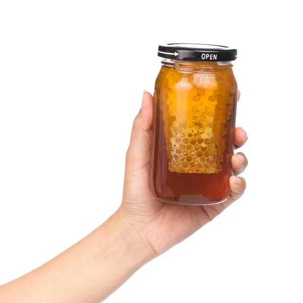 白い背景に分離された蜂蜜の瓶を持っている手 — ストック写真