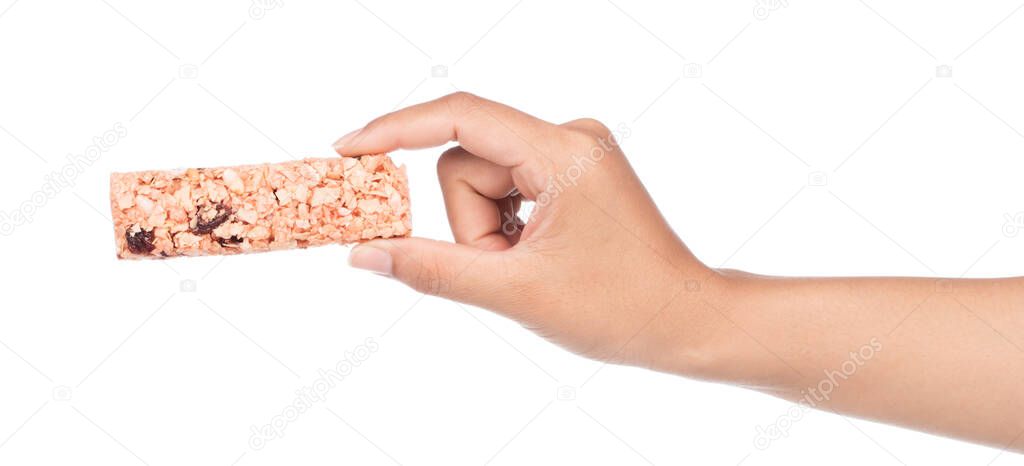 hand holding Munchies health Cereal candy bar isolated on white background.