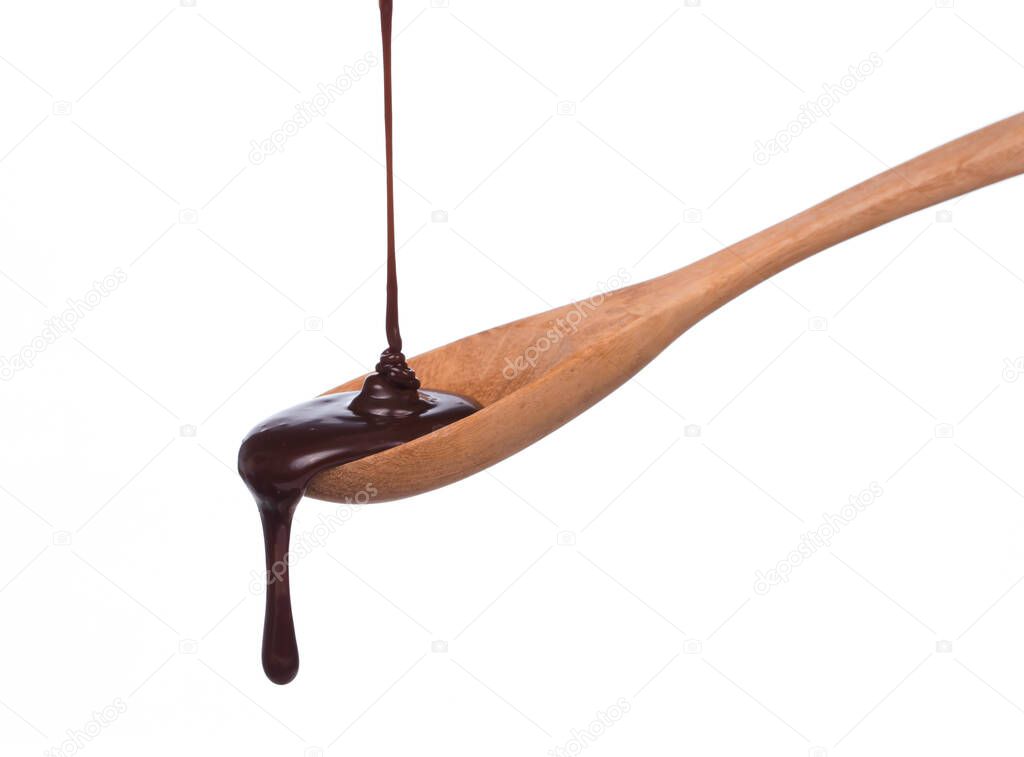 chocolate dripping from a wood spoon isolated on white background