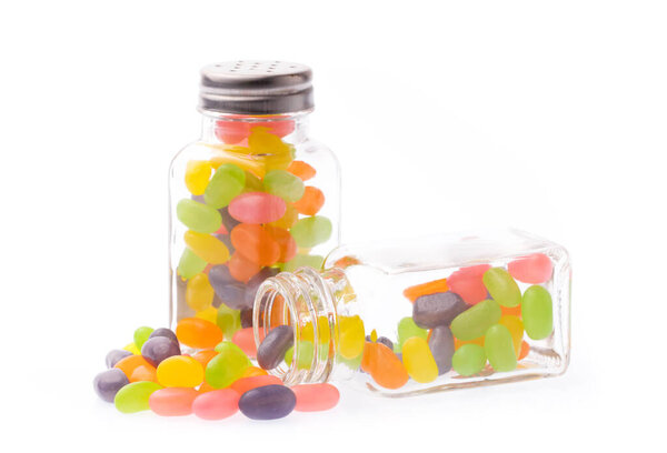 jelly bean candies on glass bottle isolated on white background