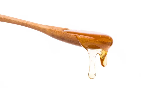 Honig Tropft Aus Einem Kochlöffel Holz Isoliert Auf Weißem Hintergrund — Stockfoto