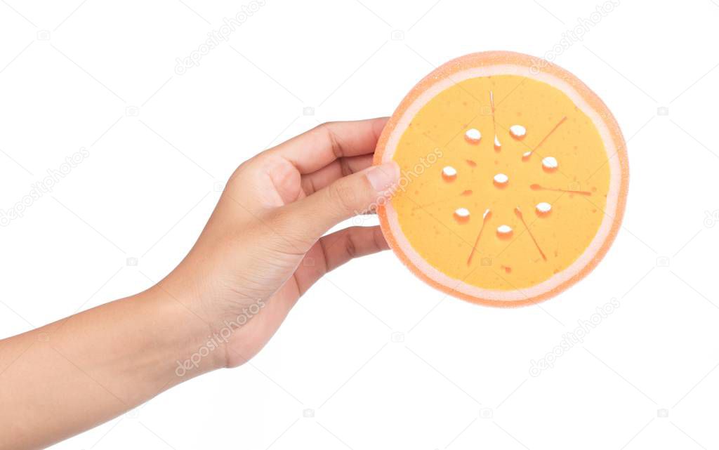 hand holding Orange sponge isolated on white background.