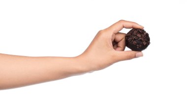 El ele tutuşan çikolata topu beyaz arka planda izole edilmiş.