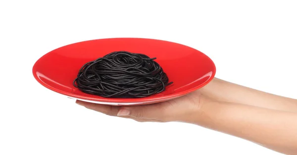 Main Tenant Spaghetti Noir Dans Plat Isolé Sur Fond Blanc — Photo