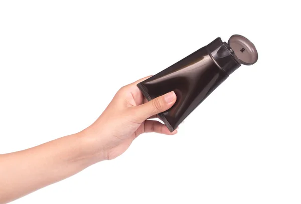 Mão Segurando Cosmético Tubo Plástico Preto Isolado Fundo Branco — Fotografia de Stock