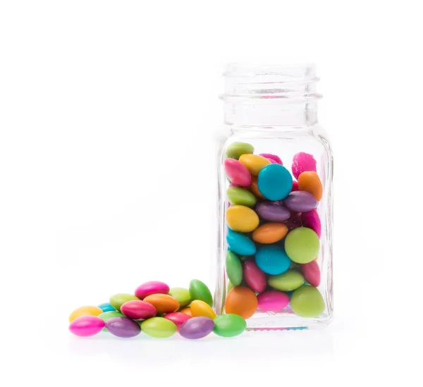 Glazen Fles Met Gekleurde Chocolade Snoepjes Knoppen Geïsoleerd Witte Achtergrond — Stockfoto