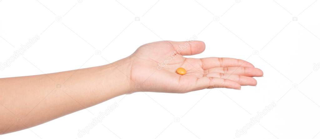 hand holding orange chocolate coated candy isolated on white background