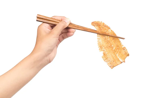 白を基調とした箸で辛みのあるカリカリイカを握る手 — ストック写真