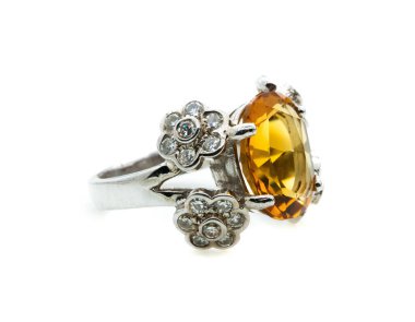 classic ring with a yellow/orange topaz stone on white background