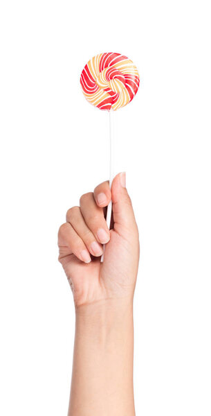 hand holding Colorful spiral lollipop  isolated on white background.