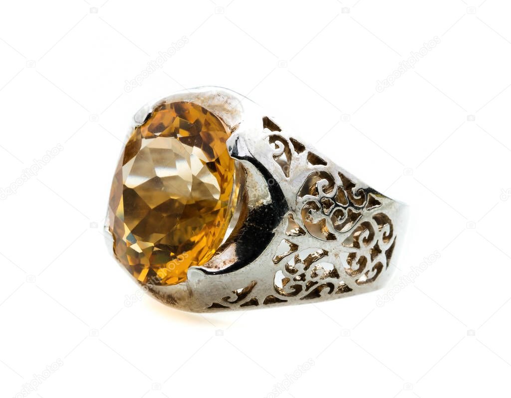 classic ring with a yellow/orange topaz stone on white background