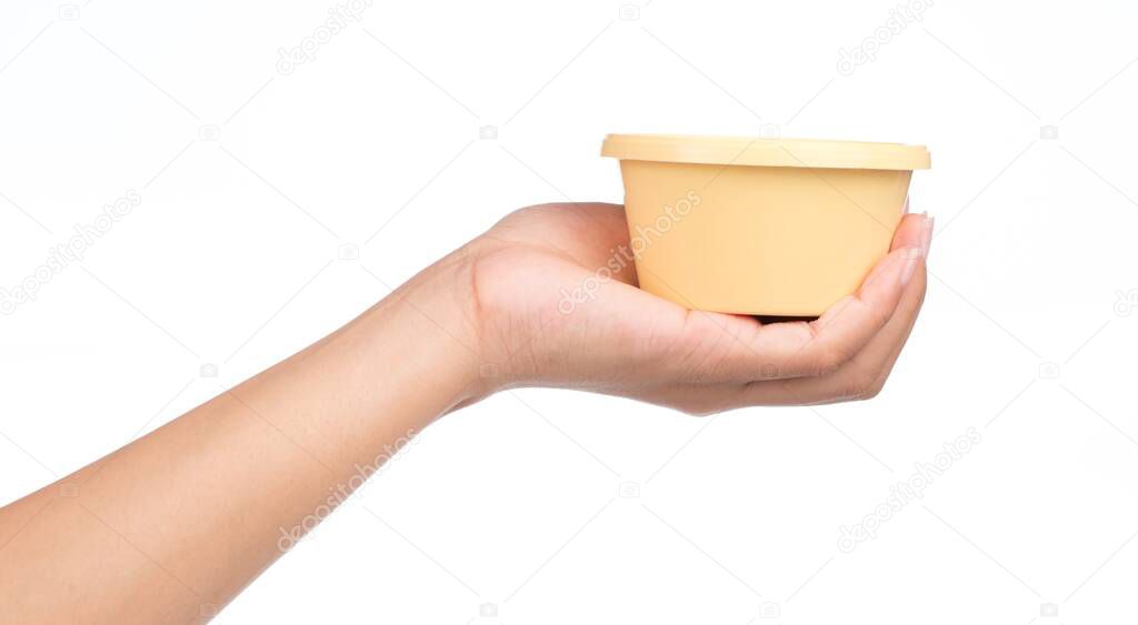 hand holding Plastic circle container for dairy foods Isolated on a white background