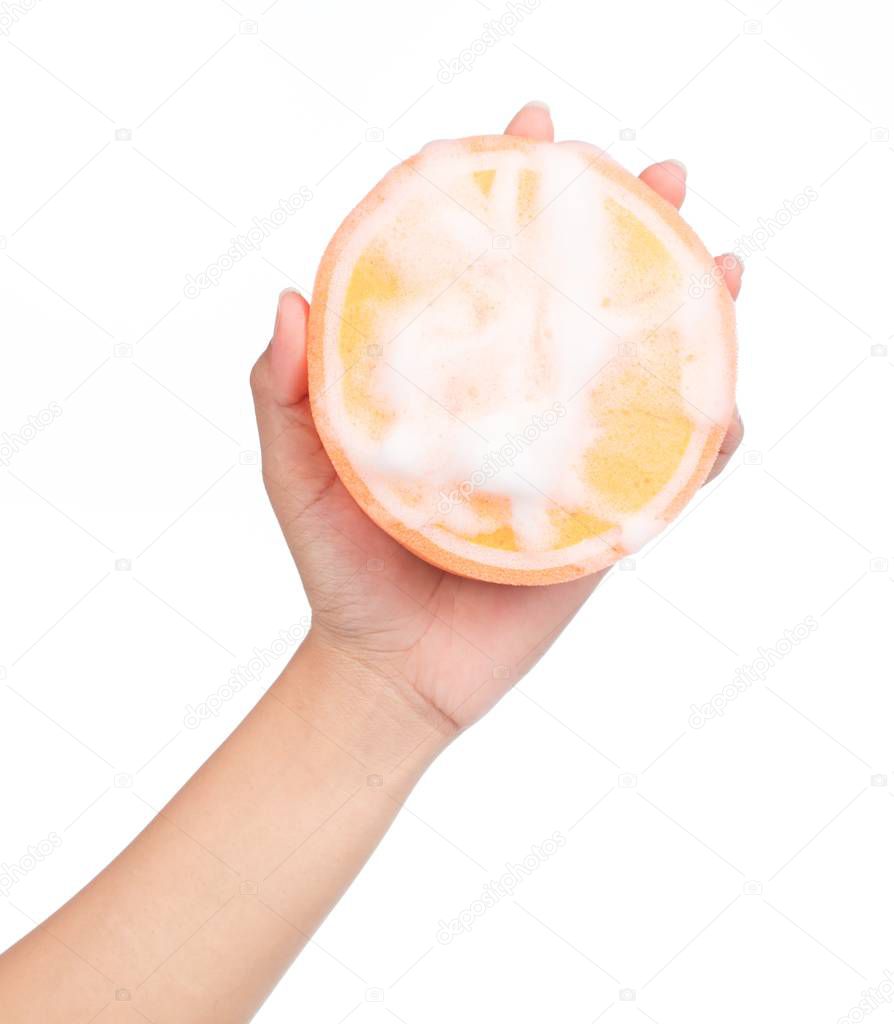 hand holding Orange sponge wet with foam isolated on white background.