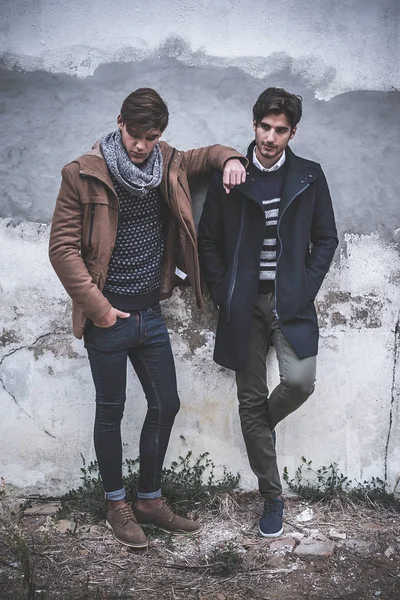 Portrait of two young man posing with fashionable winter clothes
