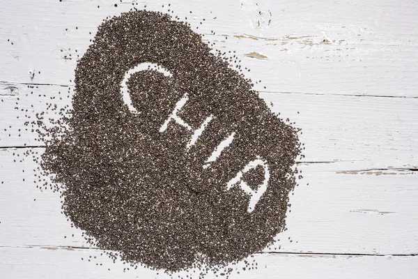 Chia seed on wooden board — Stock Photo, Image