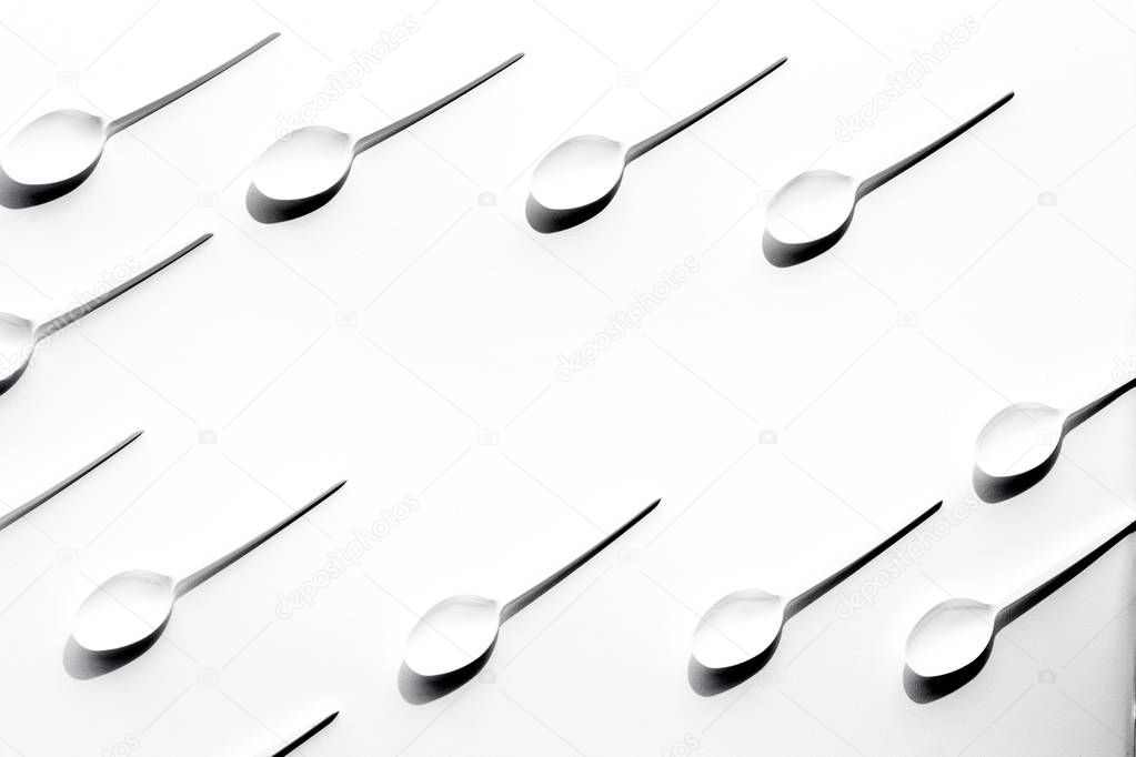 Flat lay photo of white plastic spoons
