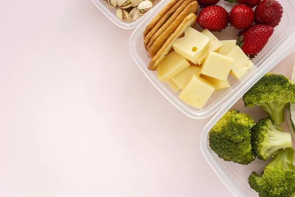 Food in Plastic containers ready to eat from above To take away. On pink background. Healthy food. Vegan food. Flat lay