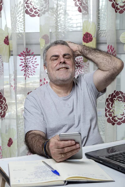 Starší Muž Plnovousem Pracuje Doma Pyžamem Notebookem Mobilním Telefonem Coronavirus — Stock fotografie