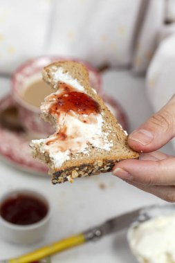 Koronavirüs tarafından karantinaya alınmış, pijamalarıyla kahvaltı eden tanınmamış bir kadın. Covid-19 konsepti. Sağlıklı yemek.
