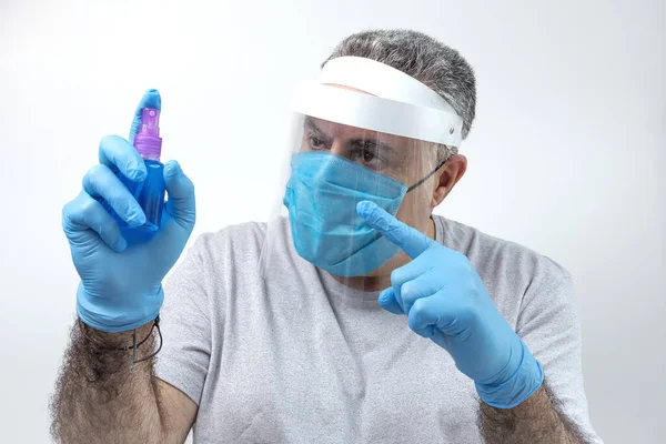 COVID-19. Adult man with double mask and latex gloves to protect himself from coronavirus on white background. Isolated