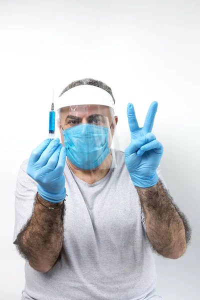 COVID-19. Adult man with double mask and latex gloves to protect himself from coronavirus on white background. Isolated