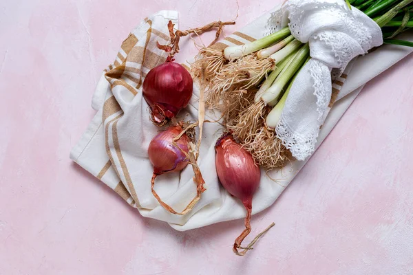 Fresh red and white onions on pink background.Vegan food.Food Ingredient