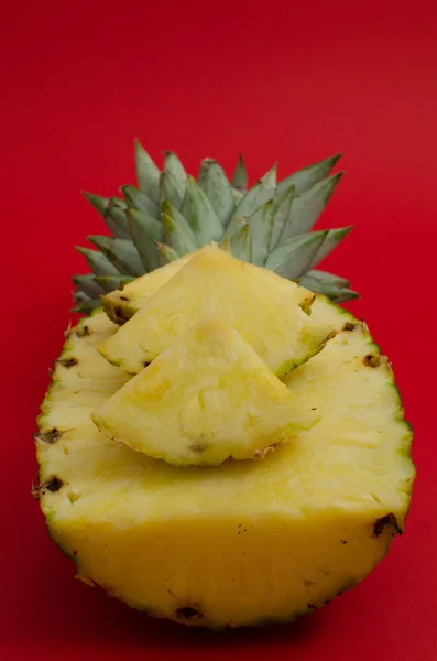 Sliced pineapple fruit on red background — Stock Photo, Image