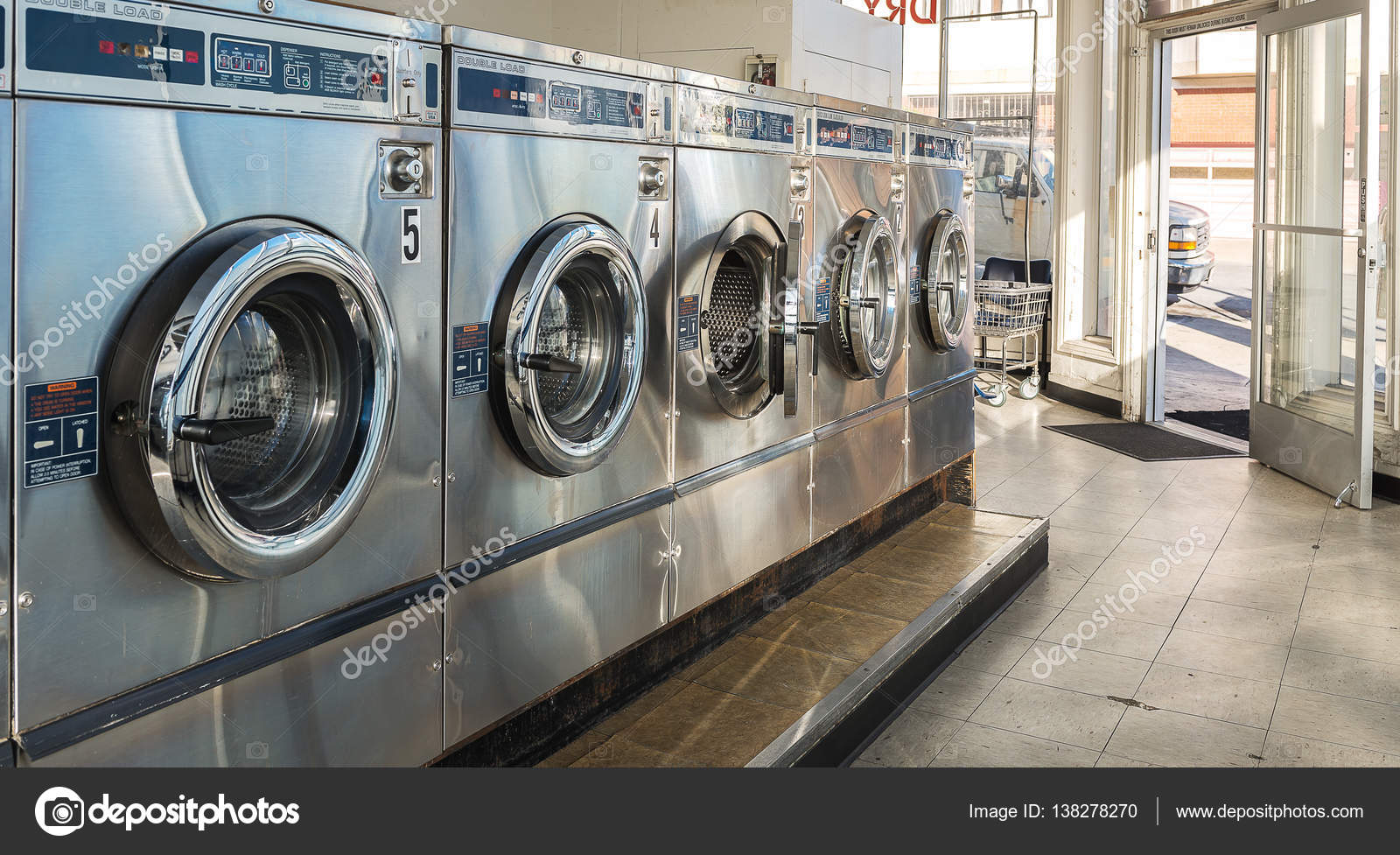 Laundry machines in public laundromat Stock Photo by ©srongkrod481