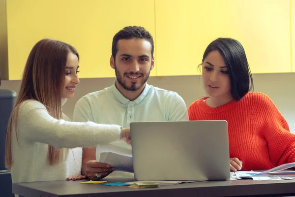 Equipo de negocios en el trabajo. Grupo de jóvenes empresarios confiados discutiendo el proyecto mientras pasan tiempo en la oficina — Foto de Stock