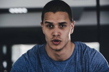 Sporcu spor salonunda koşu bandında egzersiz yapıyor.