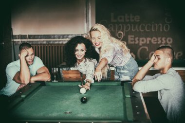 Young people playing snooker