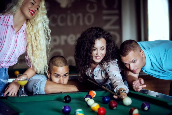 Young people playing snooker